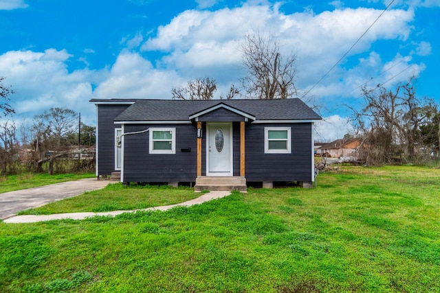 bungalow-style home featuring a front yard