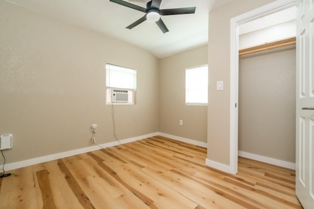 unfurnished bedroom featuring vaulted ceiling, a closet, cooling unit, ceiling fan, and light hardwood / wood-style floors