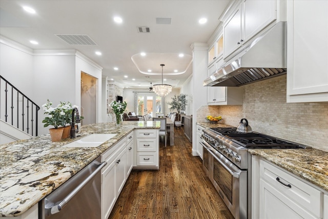 kitchen featuring sink, white cabinetry, light stone counters, hanging light fixtures, and stainless steel appliances