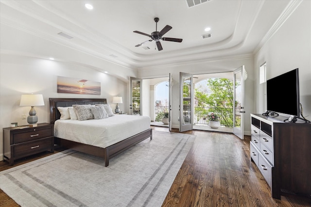 bedroom with ornamental molding, access to exterior, ceiling fan, a raised ceiling, and dark wood-type flooring