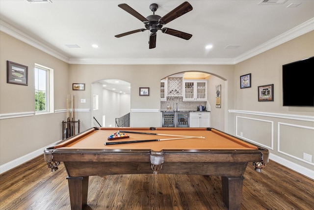 rec room with wine cooler, dark hardwood / wood-style flooring, bar, ceiling fan, and crown molding