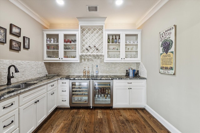 bar featuring white cabinetry and beverage cooler