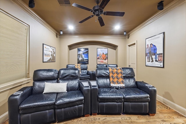 cinema featuring crown molding, light hardwood / wood-style flooring, and ceiling fan