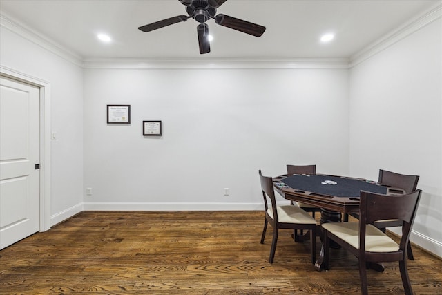 dining room featuring ornamental molding, dark wood-type flooring, and ceiling fan