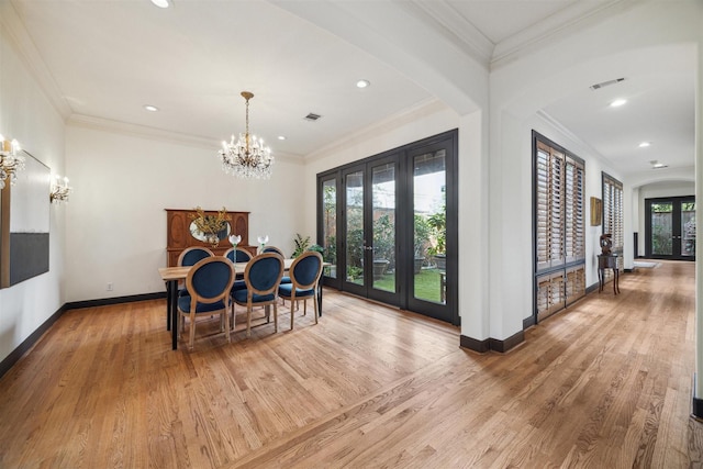 dining area with french doors, wood-type flooring, and crown molding