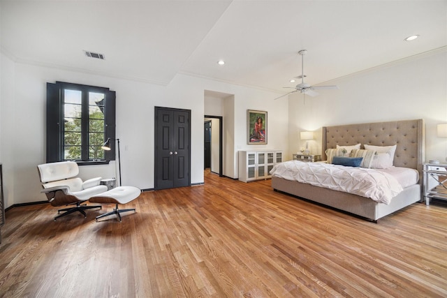 bedroom featuring ceiling fan, ornamental molding, and light hardwood / wood-style floors