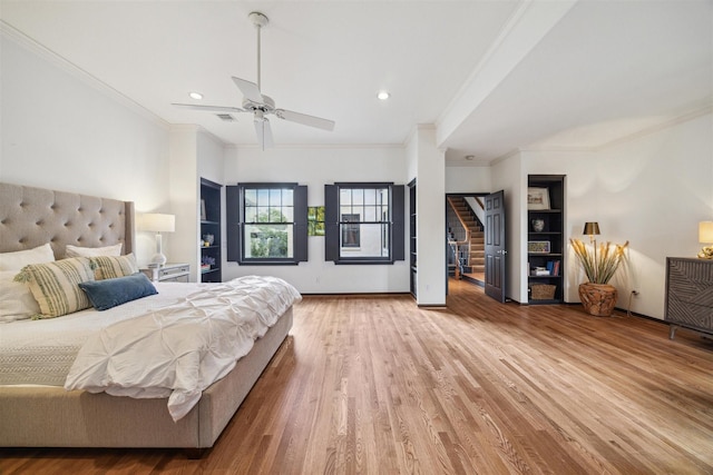 bedroom with ceiling fan, wood-type flooring, and ornamental molding