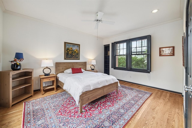 bedroom with crown molding, ceiling fan, and light hardwood / wood-style flooring