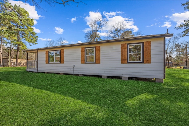 rear view of property with a lawn