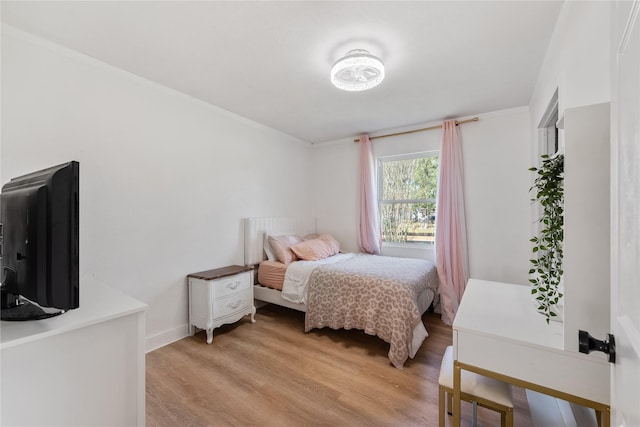 bedroom featuring light wood-type flooring and baseboards