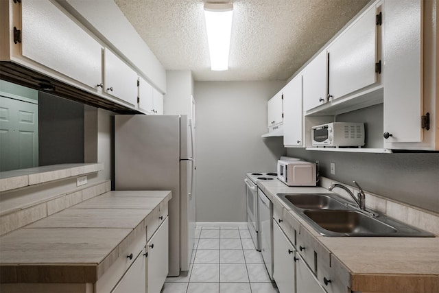 kitchen with white cabinetry, white appliances, sink, and a textured ceiling