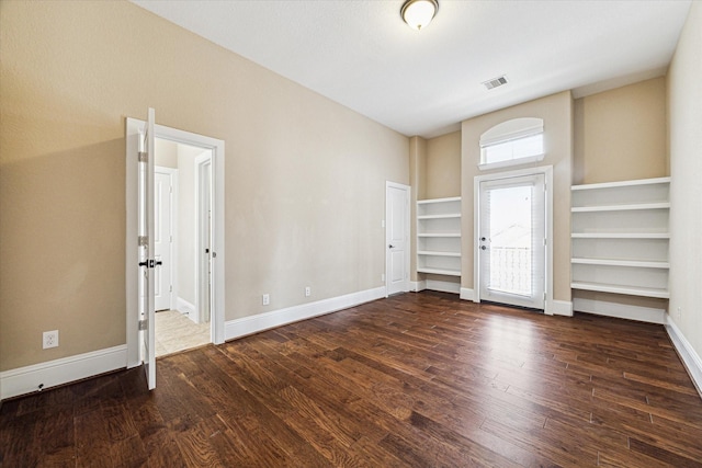 spare room featuring dark hardwood / wood-style floors