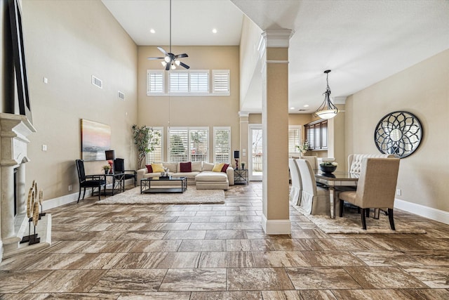 living room with decorative columns and ceiling fan