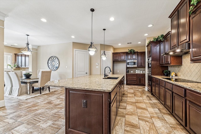 kitchen with sink, hanging light fixtures, an island with sink, and appliances with stainless steel finishes