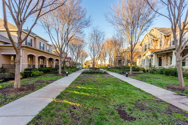 view of home's community featuring a lawn