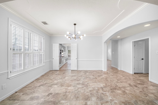 unfurnished dining area featuring crown molding and a chandelier