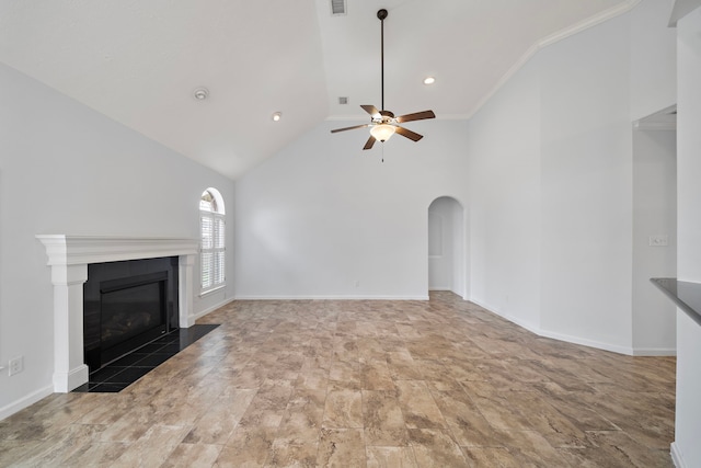 unfurnished living room with ceiling fan, ornamental molding, a fireplace, and high vaulted ceiling