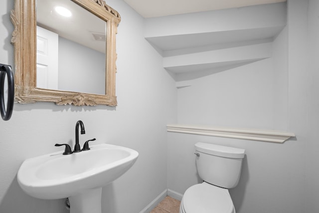 bathroom with tile patterned flooring, sink, and toilet