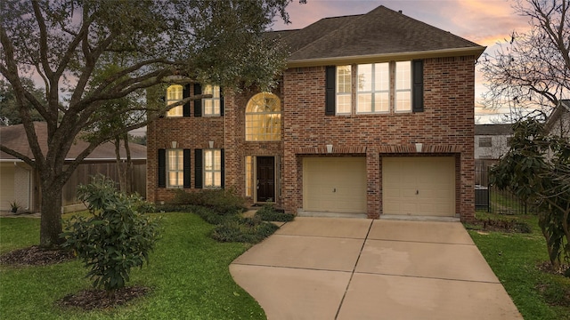 view of front of house with a garage and a yard