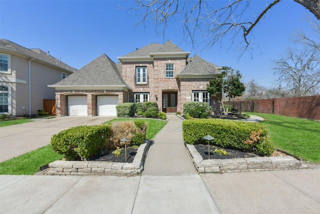 view of front of home with brick siding, concrete driveway, fence, a garage, and a front lawn