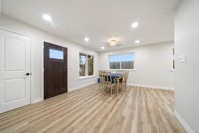 dining space with light hardwood / wood-style flooring