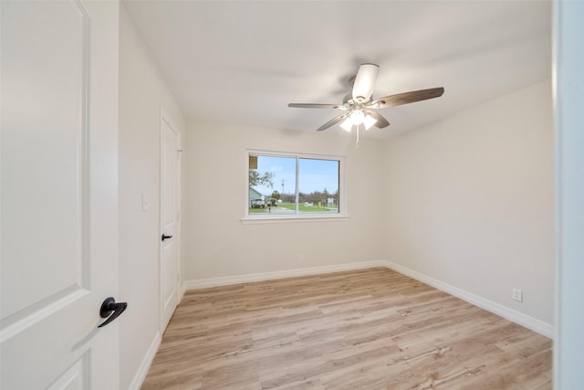empty room featuring ceiling fan and light hardwood / wood-style flooring