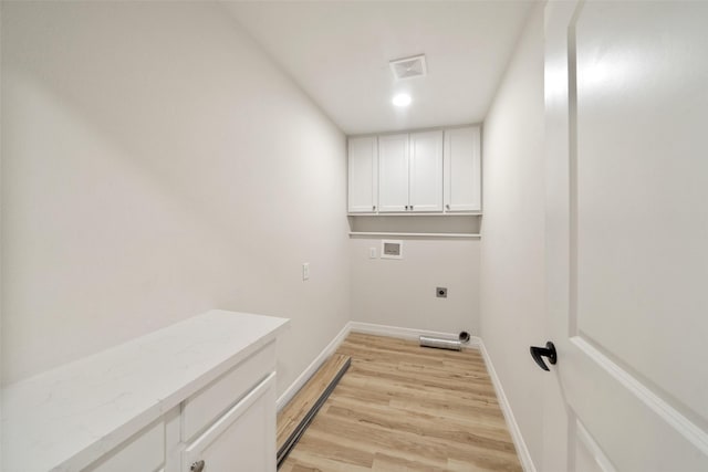 laundry area featuring cabinets, hookup for a washing machine, light hardwood / wood-style flooring, and electric dryer hookup