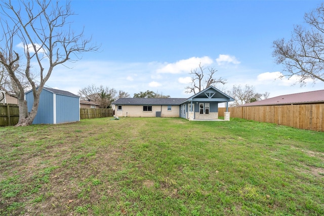 back of house with a storage shed and a yard