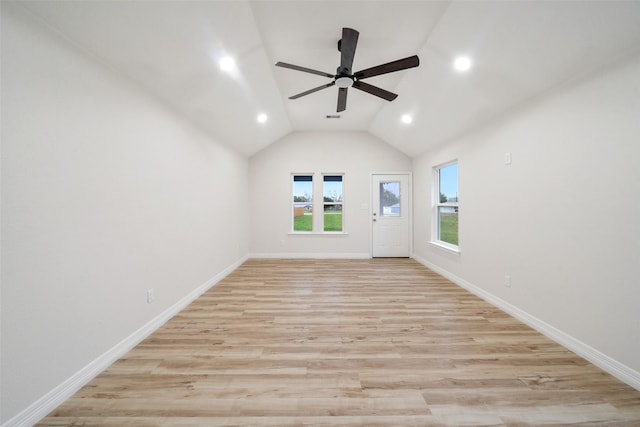 empty room with vaulted ceiling, ceiling fan, and light hardwood / wood-style flooring