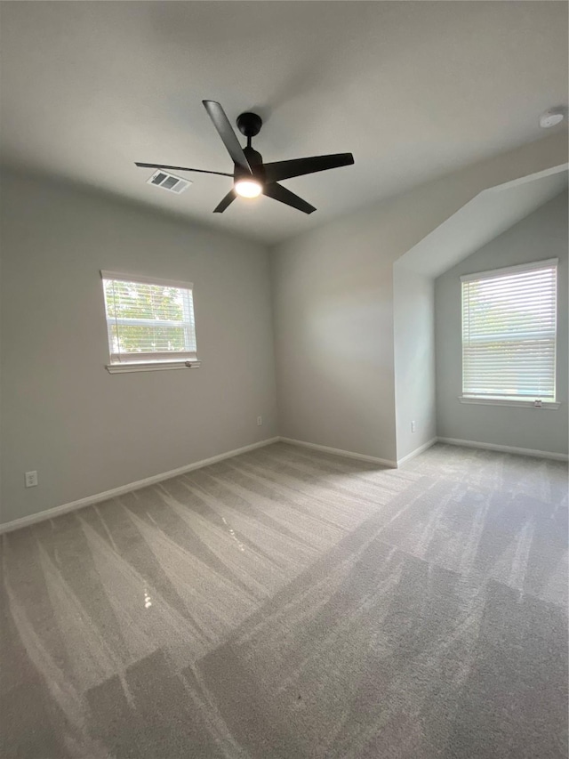 carpeted spare room with ceiling fan