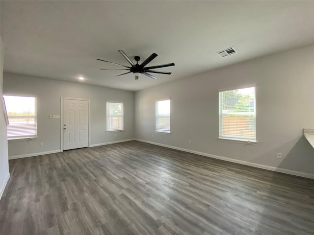 interior space with dark wood-type flooring and ceiling fan