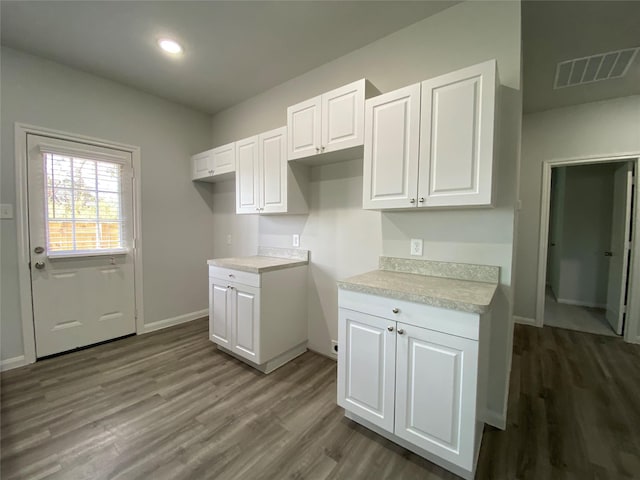 kitchen featuring white cabinetry and hardwood / wood-style floors