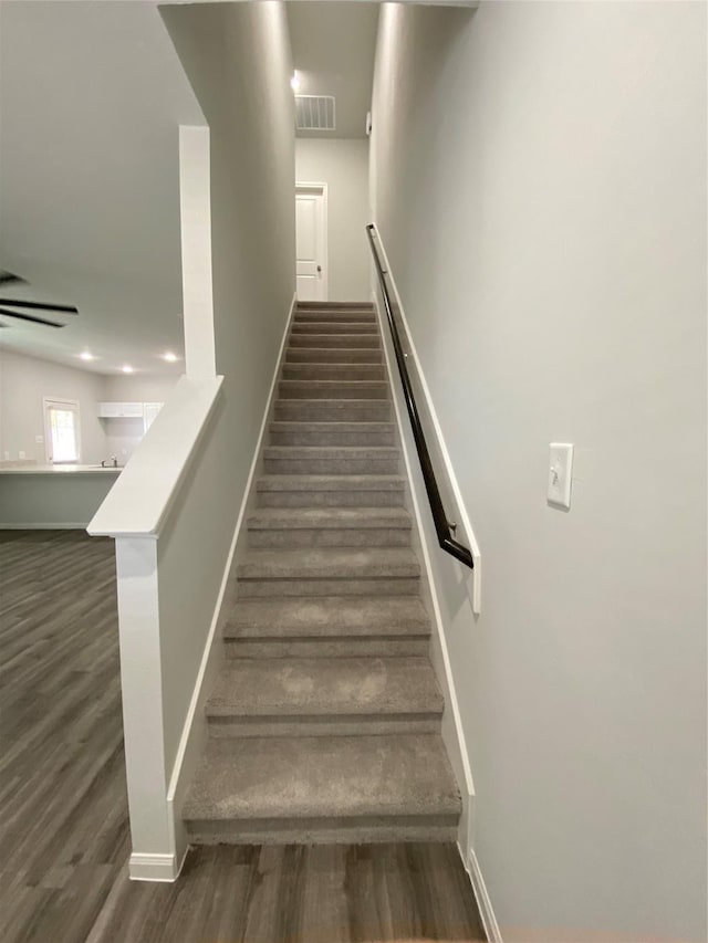 staircase with hardwood / wood-style flooring