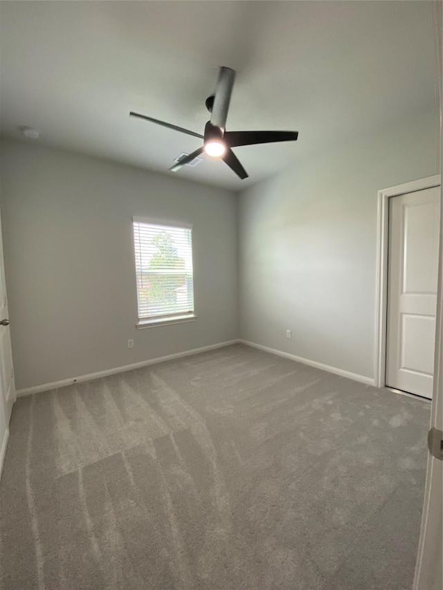 unfurnished room with carpet floors and ceiling fan