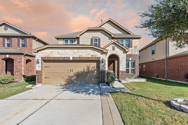 view of front of property with a yard and a garage