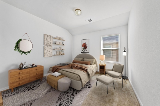 bedroom with vaulted ceiling and light carpet