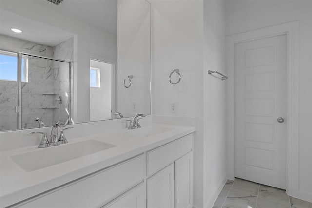 3318 Verdant, Richmond, TX 77406 - full bathroom featuring marble look tiles, a marble finish shower, double vanity, and plenty of natural light