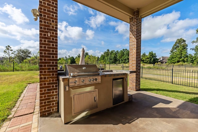 view of patio featuring a grill and exterior kitchen