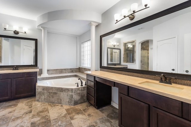 bathroom with backsplash, vanity, separate shower and tub, and ornate columns