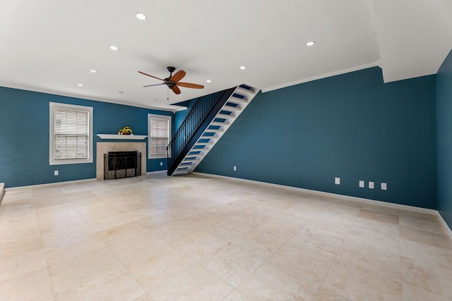 unfurnished living room with a fireplace, recessed lighting, ornamental molding, baseboards, and stairs