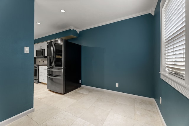 kitchen with baseboards, white cabinetry, appliances with stainless steel finishes, and crown molding