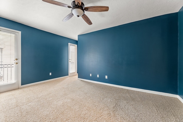 unfurnished room featuring a textured ceiling, carpet flooring, a ceiling fan, and baseboards