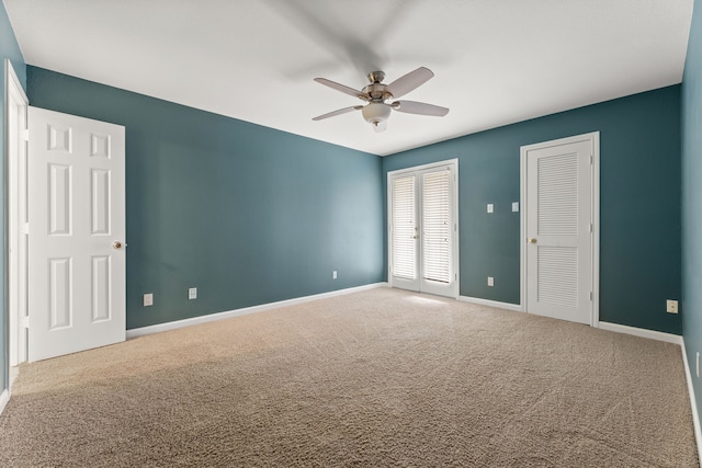 unfurnished bedroom featuring carpet floors, baseboards, and a ceiling fan