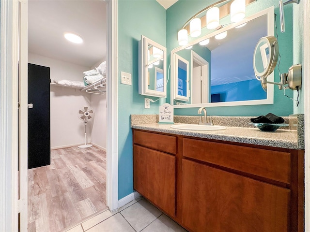 bathroom featuring tile patterned flooring and vanity