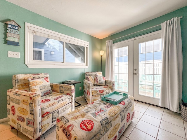 sitting room with light tile patterned floors and french doors