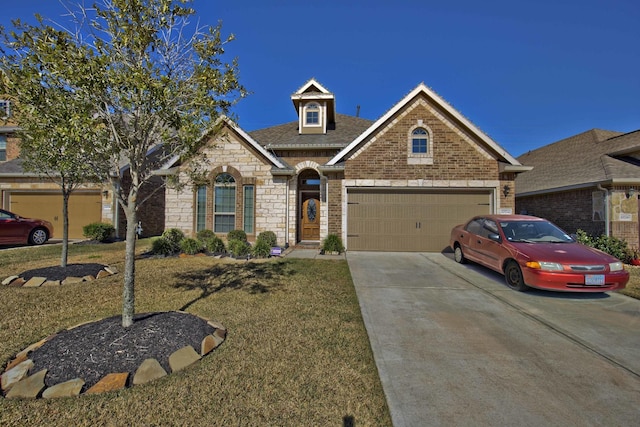 view of front of home with a garage and a front yard