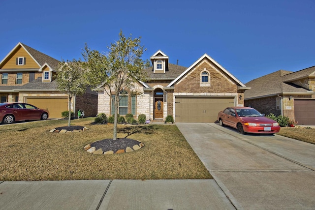 view of front of property featuring a garage and a front lawn