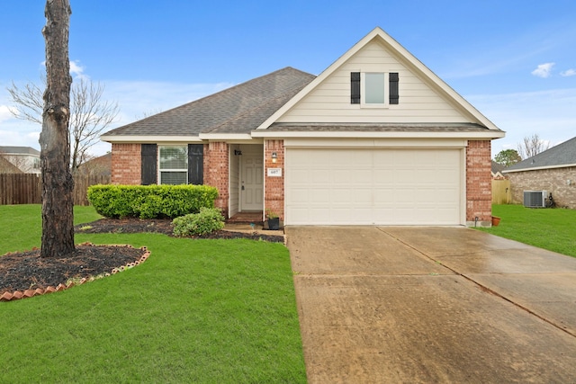 view of front of property with a garage, a front yard, and central air condition unit