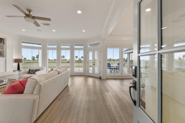 living room featuring crown molding, ceiling fan, light hardwood / wood-style floors, and french doors