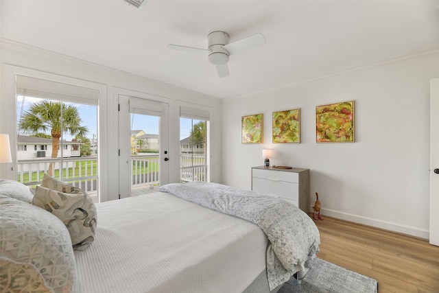 bedroom with crown molding, ceiling fan, light hardwood / wood-style floors, and access to outside